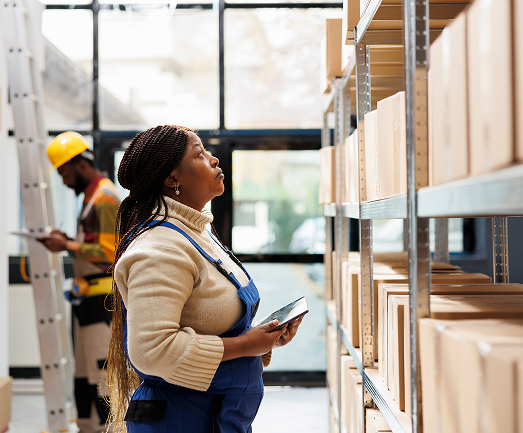 woman standing in front of boxes at factory